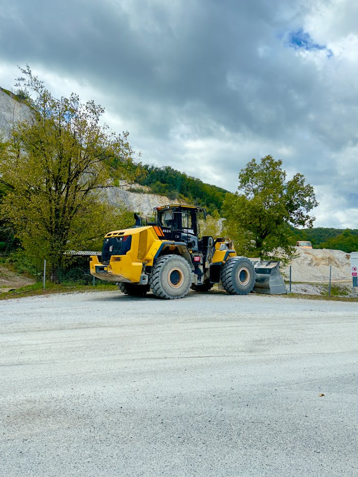 A powerful yellow bulldozer in a Croatian quarry, showcasing construction equipment amidst nature.